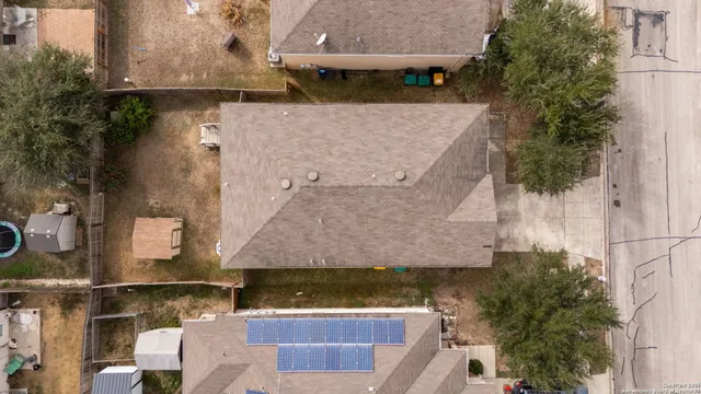 an aerial view of a house with a yard