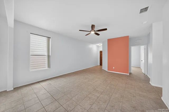 a view of a livingroom with a ceiling fan and window