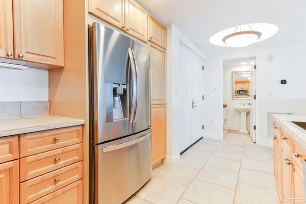 a kitchen with stainless steel appliances a refrigerator and cabinets