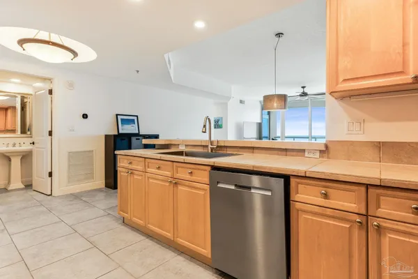 a kitchen with stainless steel appliances granite countertop a sink and a refrigerator