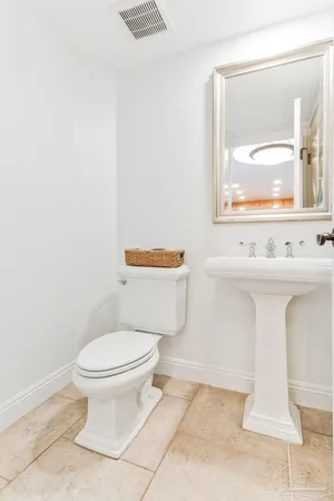 a white toilet sitting next to a bathroom sink