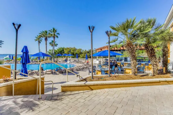 a view of a swimming pool with outdoor seating