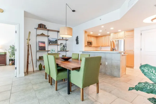a room with stainless steel appliances kitchen island granite countertop furniture and a view of kitchen