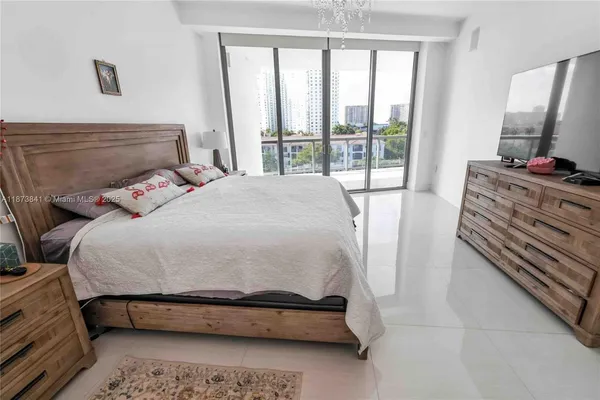 a bedroom with a bed and flat tv screen