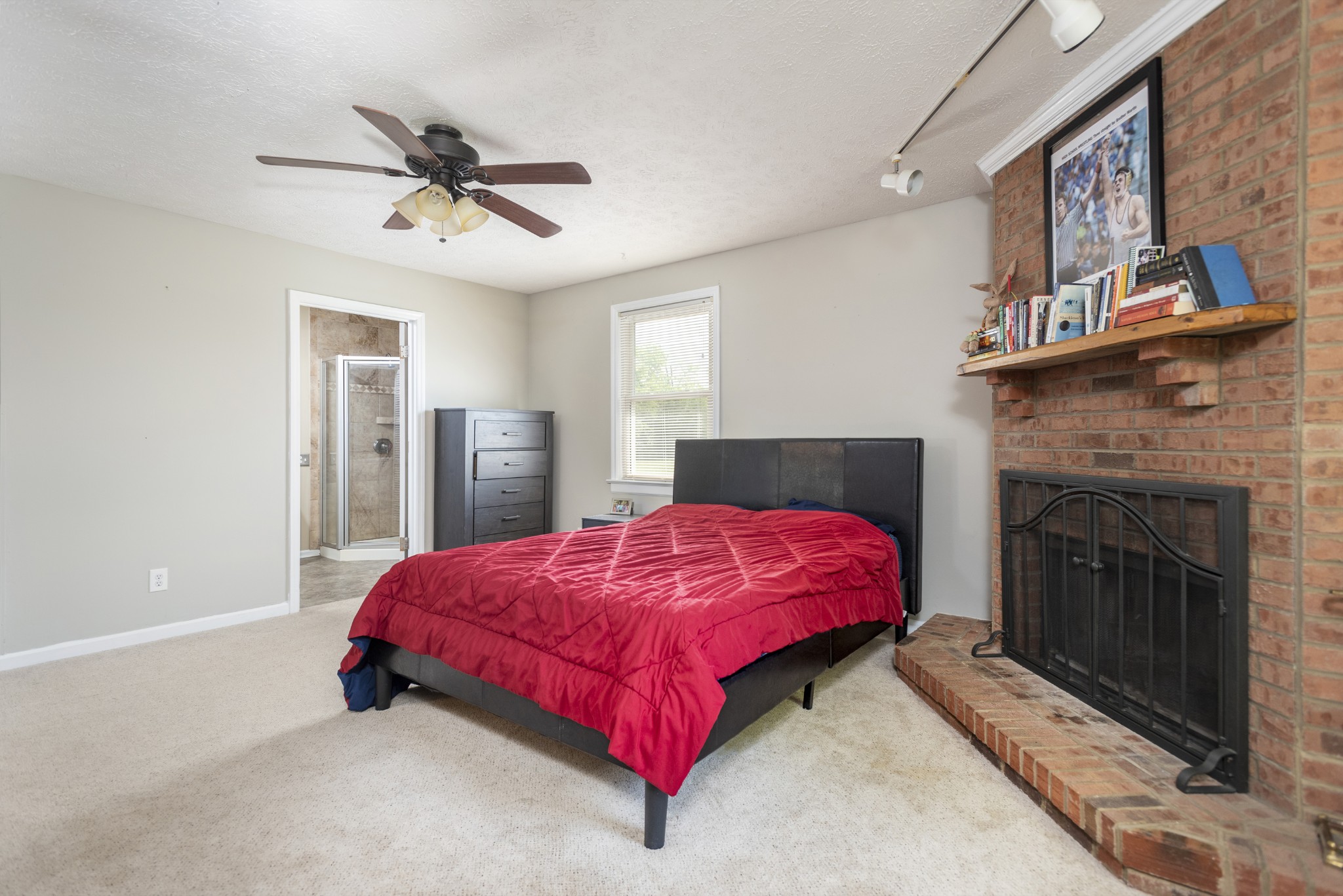 598 Franklin Road Lebanon, TN 37087 - Photo 8 of 18 a spacious bedroom with a bed and a fireplace