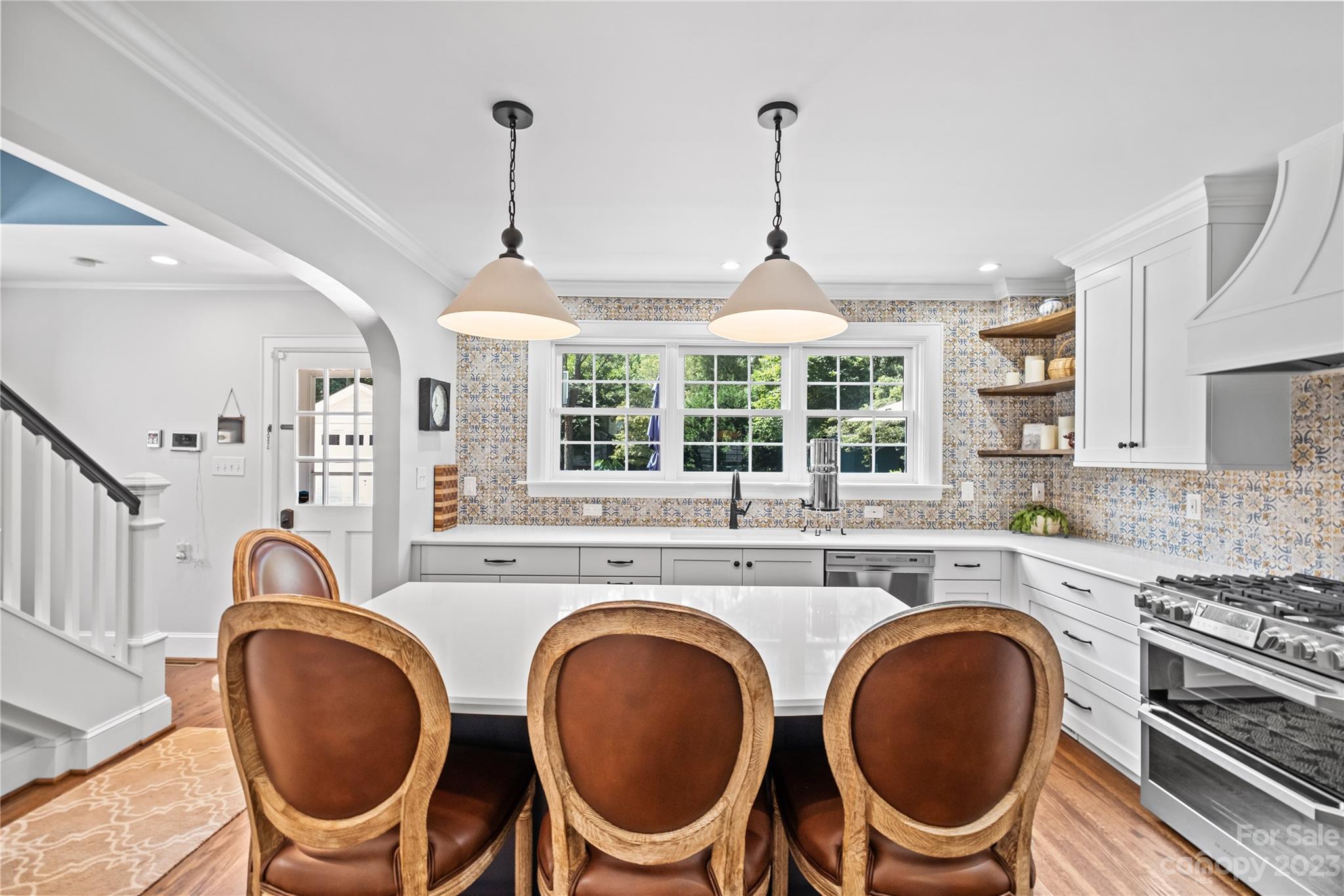 1324 Goodwin Avenue Charlotte, NC 28205 - Photo 8 of 29 a kitchen with kitchen island a stove and a wooden floors