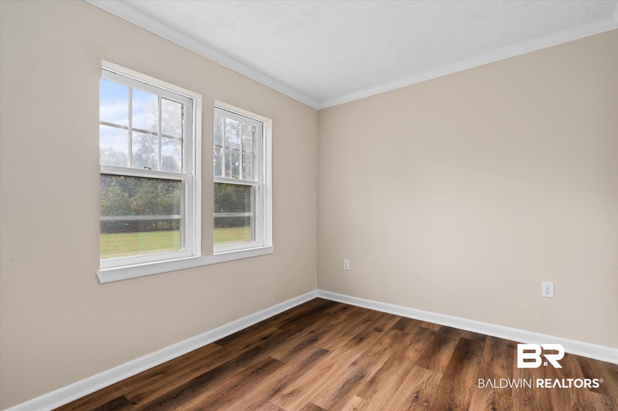 4630 General Road Mobile, AL 36619 - Photo 14 of 33 Unfurnished room with dark hardwood / wood-style floors and crown molding