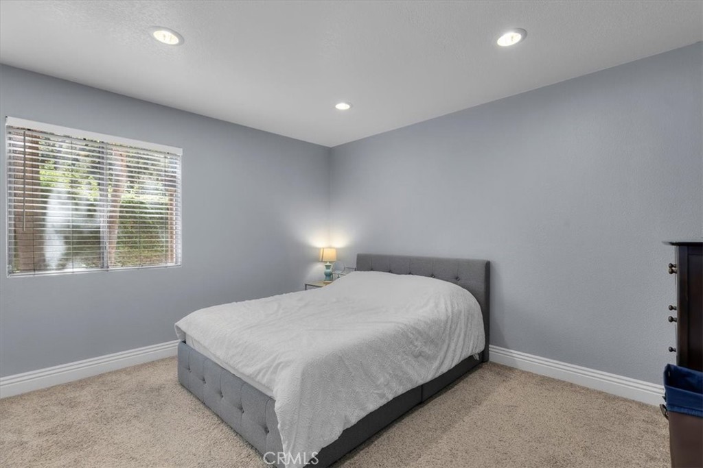 20914 Serrano Creek Road, Unit 48 Lake Forest, CA 92630 - Photo 11 of 22 a large bed sitting in a bedroom next to a window