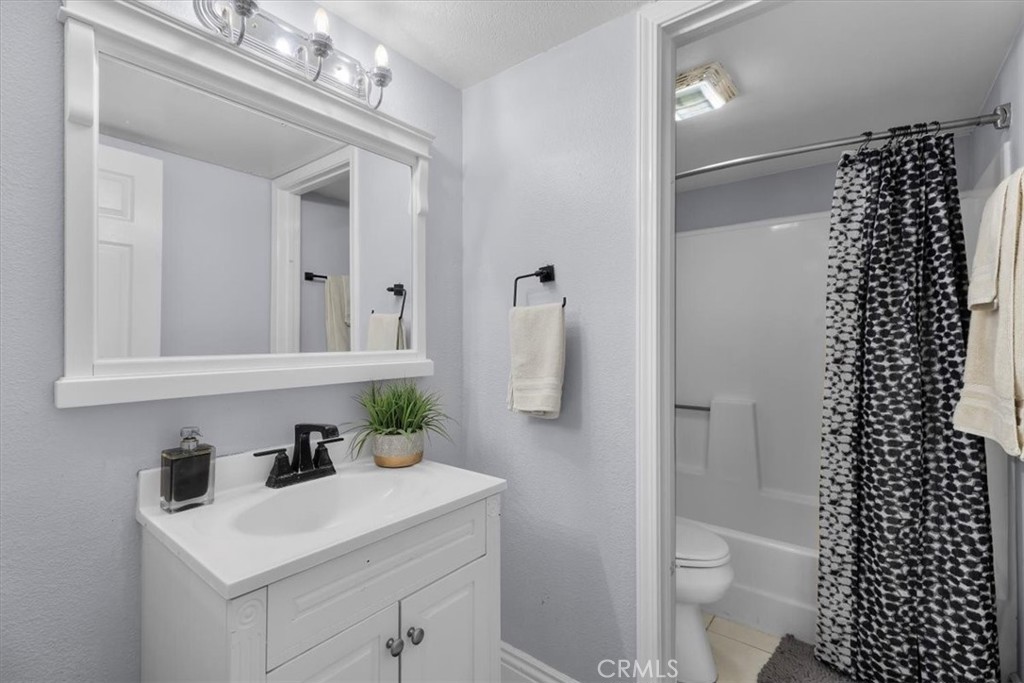 20914 Serrano Creek Road, Unit 48 Lake Forest, CA 92630 - Photo 14 of 22 a bathroom with a sink a toilet and shower