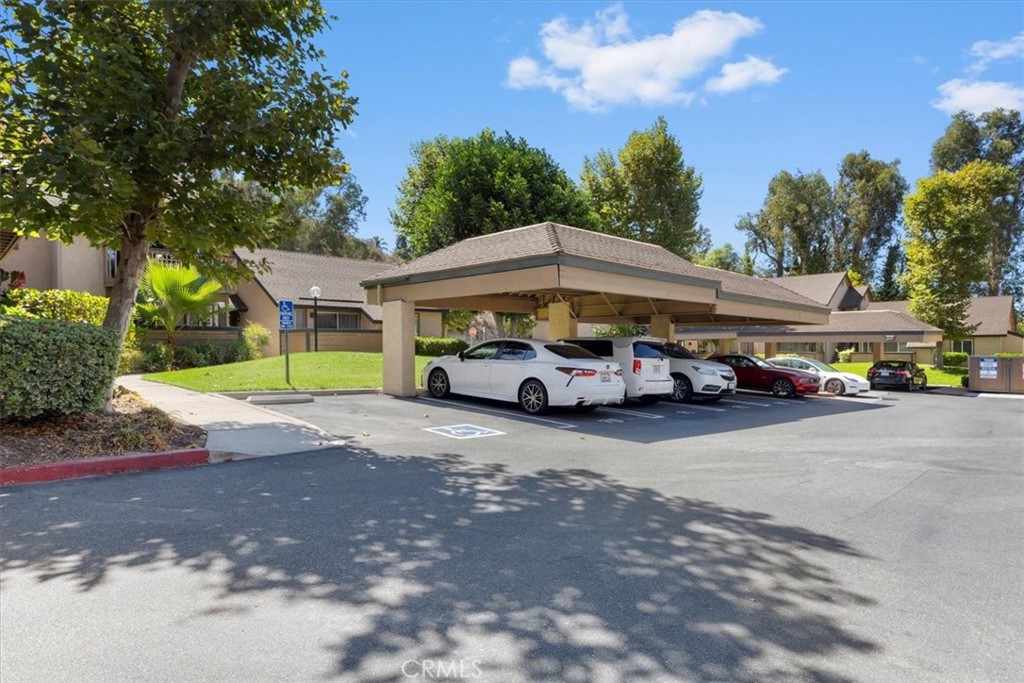 20914 Serrano Creek Road, Unit 48 Lake Forest, CA 92630 - Photo 20 of 22 a car parked in front of a house with a yard