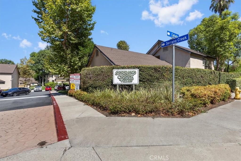 20914 Serrano Creek Road, Unit 48 Lake Forest, CA 92630 - Photo 21 of 22 a front view of a house with a yard and potted plants