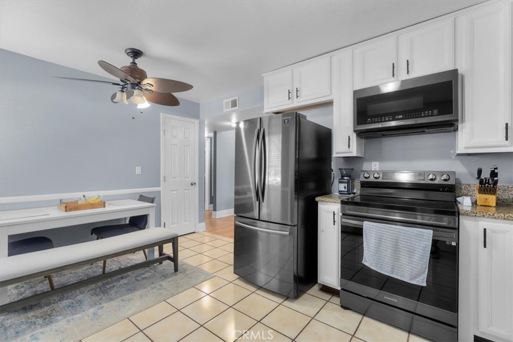 20914 Serrano Creek Road, Unit 48 Lake Forest, CA 92630 - Photo 9 of 22 a kitchen with stainless steel appliances a stove a microwave and a refrigerator