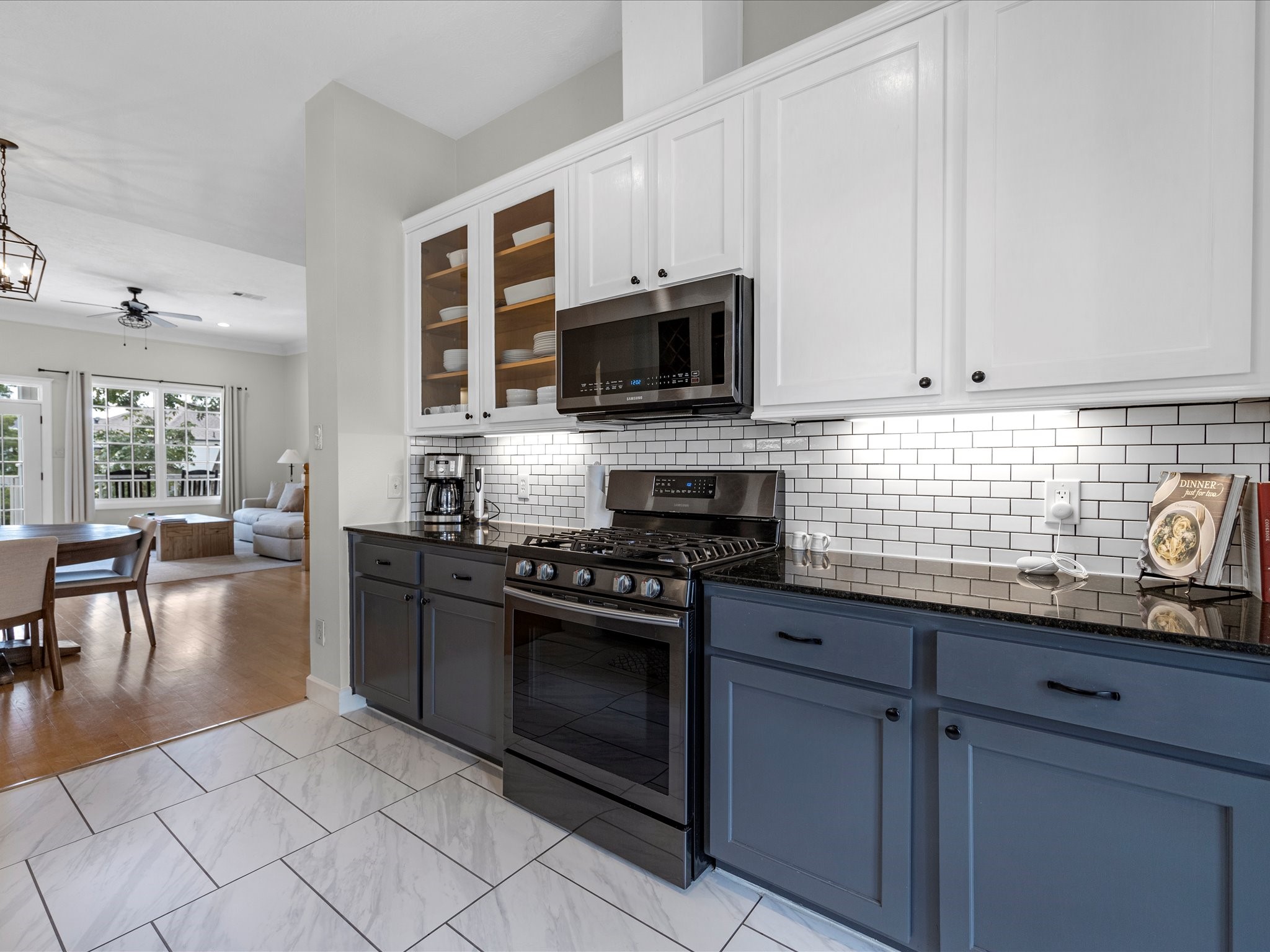 403 East 25th Street Houston, TX 77008 - Photo 7 of 16 a kitchen with granite countertop a stove a sink and a microwave