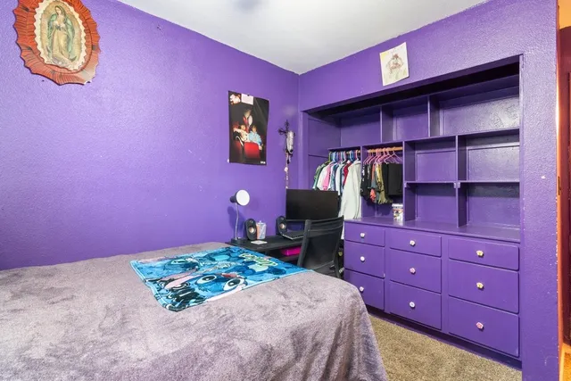a bedroom with a bed and a dresser