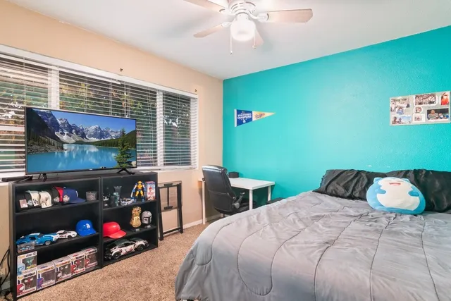 a bedroom with a bed and a window