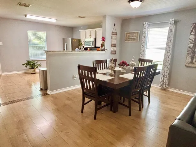 a view of a dining room with furniture and wooden floor