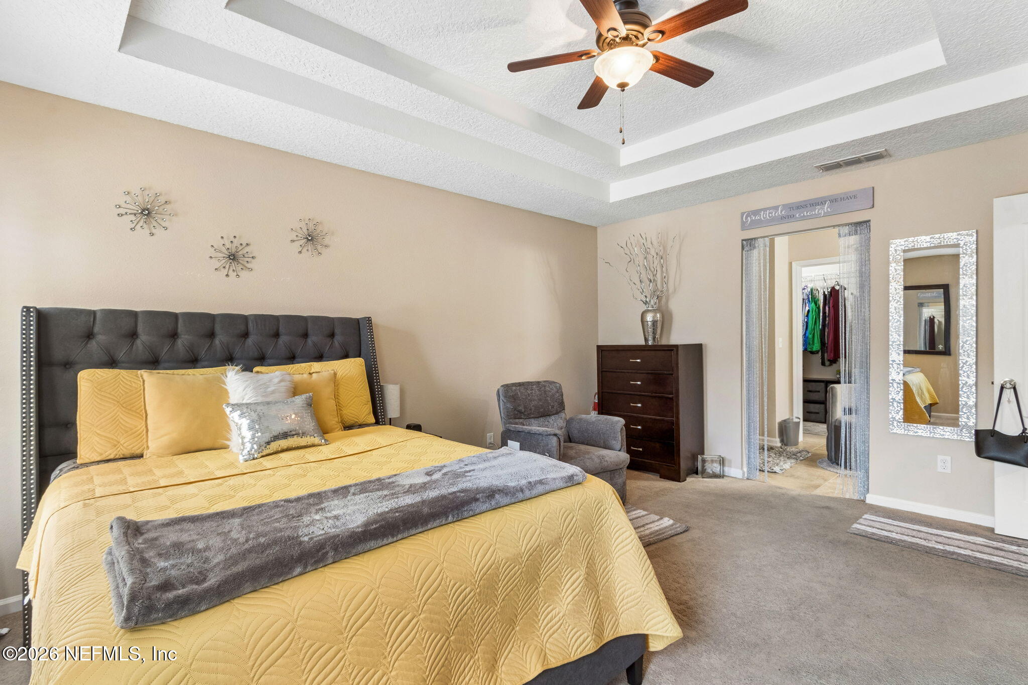 96034 Bass Lane Yulee, FL 32097 - Photo 30 of 50 a bedroom with a bed and a chandelier