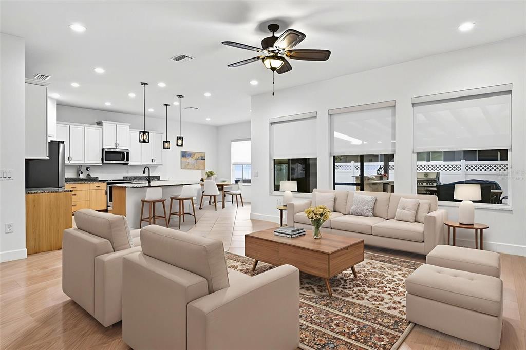 33487 Azalea Ridge Drive Wesley Chapel, FL 33545 - Photo 16 of 56 a living room with furniture kitchen view and a chandelier