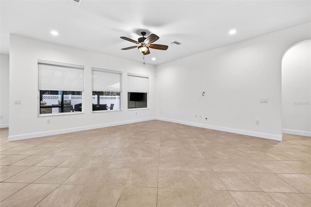 33487 Azalea Ridge Drive Wesley Chapel, FL 33545 - Photo 17 of 56 a view of a kitchen with furniture and a ceiling fan