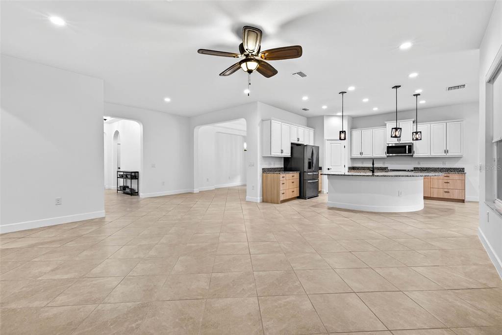 33487 Azalea Ridge Drive Wesley Chapel, FL 33545 - Photo 19 of 56 a view of a kitchen with kitchen island white cabinets and stainless steel appliances