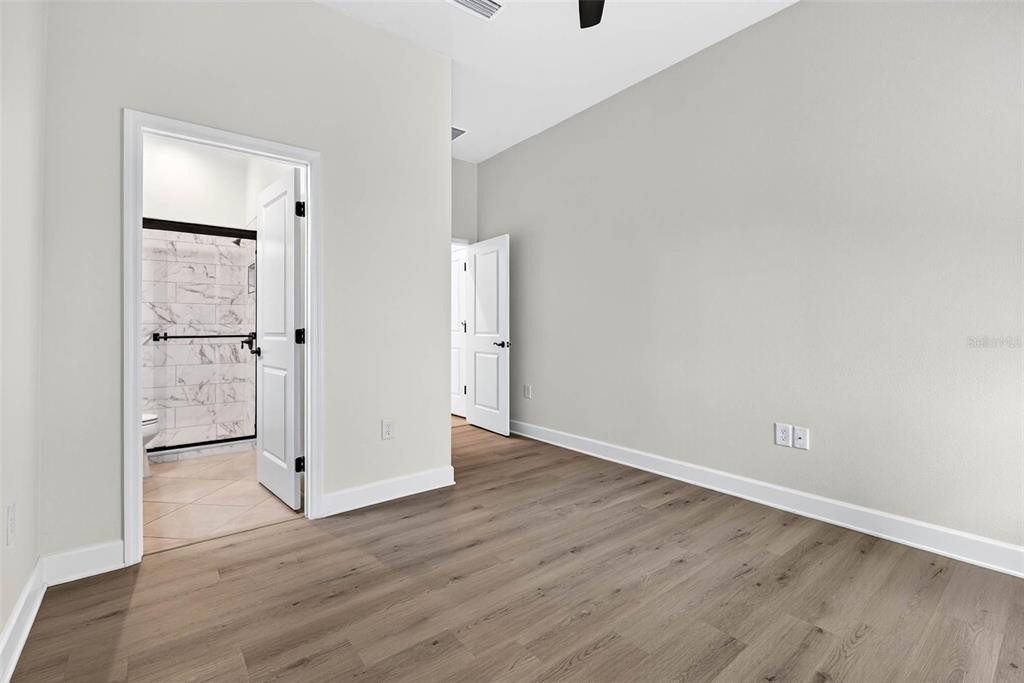 33487 Azalea Ridge Drive Wesley Chapel, FL 33545 - Photo 22 of 56 an empty room with wooden floor and closet