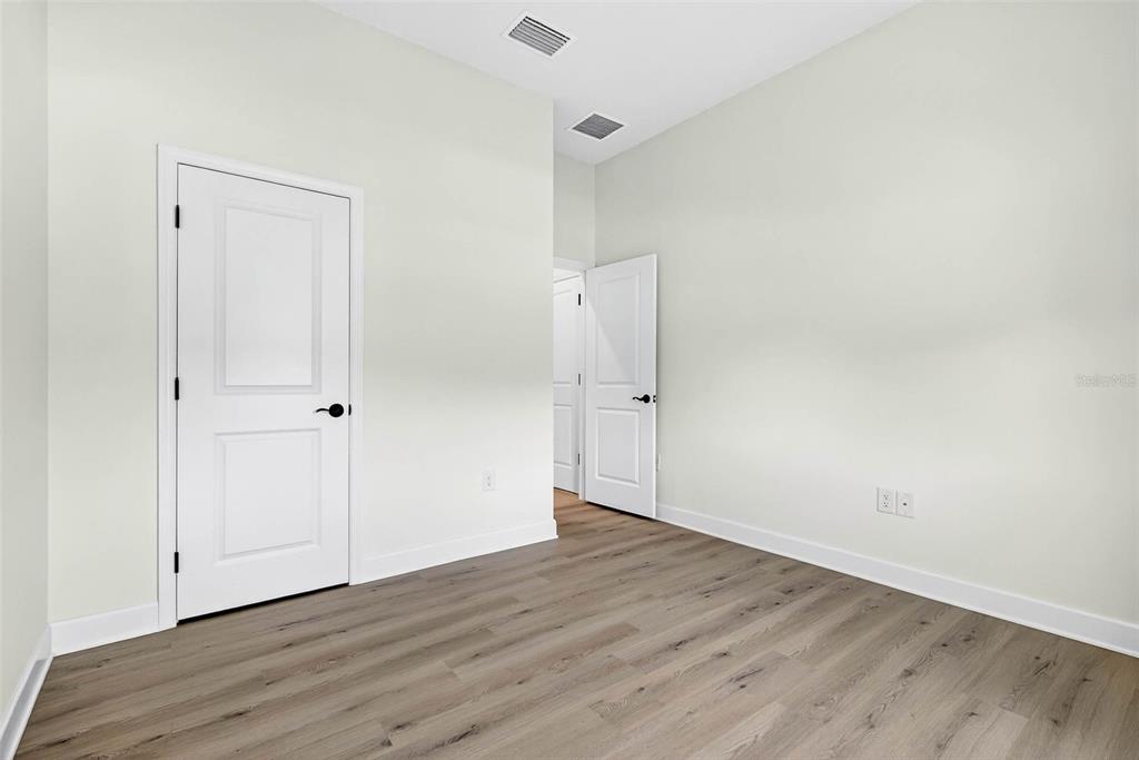 33487 Azalea Ridge Drive Wesley Chapel, FL 33545 - Photo 23 of 56 a view of an empty room with wooden floor