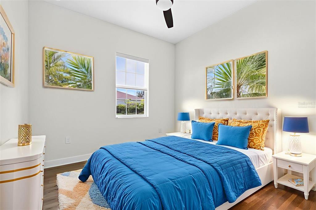 33487 Azalea Ridge Drive Wesley Chapel, FL 33545 - Photo 25 of 56 a bedroom with a bed and a painting on the wall