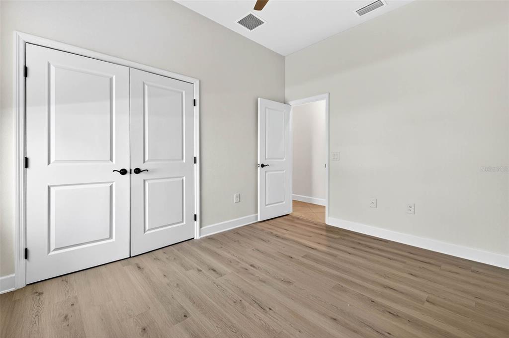 33487 Azalea Ridge Drive Wesley Chapel, FL 33545 - Photo 29 of 56 an empty room with wooden floor and white wall