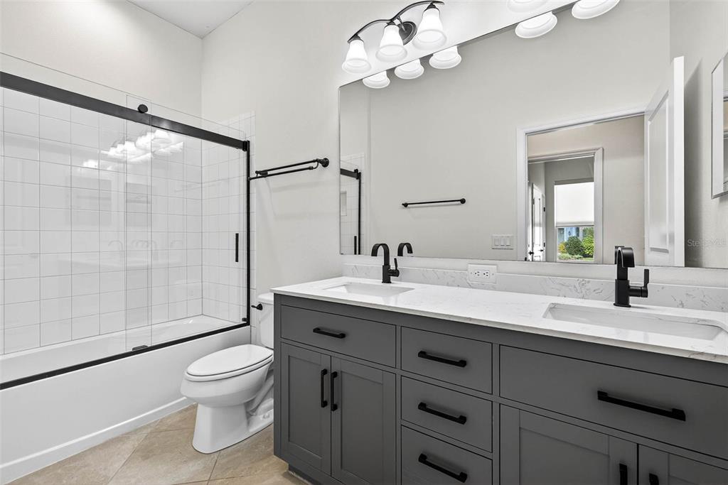 33487 Azalea Ridge Drive Wesley Chapel, FL 33545 - Photo 30 of 56 a bathroom with a sink a toilet and shower