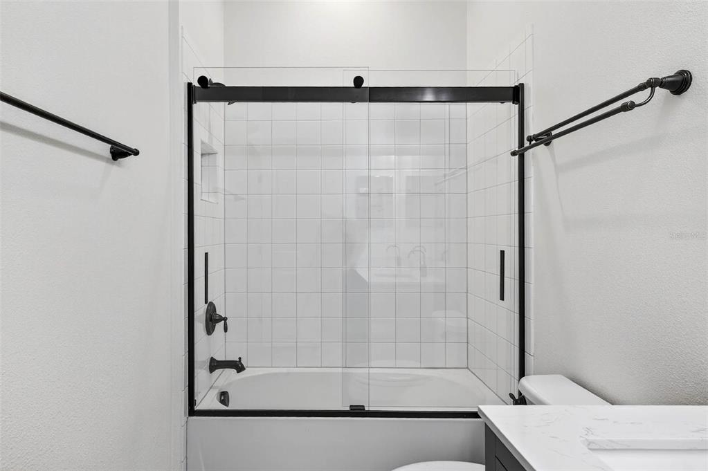 33487 Azalea Ridge Drive Wesley Chapel, FL 33545 - Photo 31 of 56 a bathroom with a shower and a bathtub