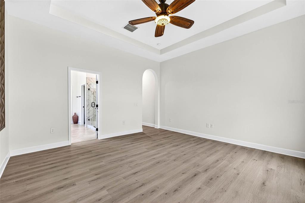 33487 Azalea Ridge Drive Wesley Chapel, FL 33545 - Photo 34 of 56 an empty room with wooden floor and windows