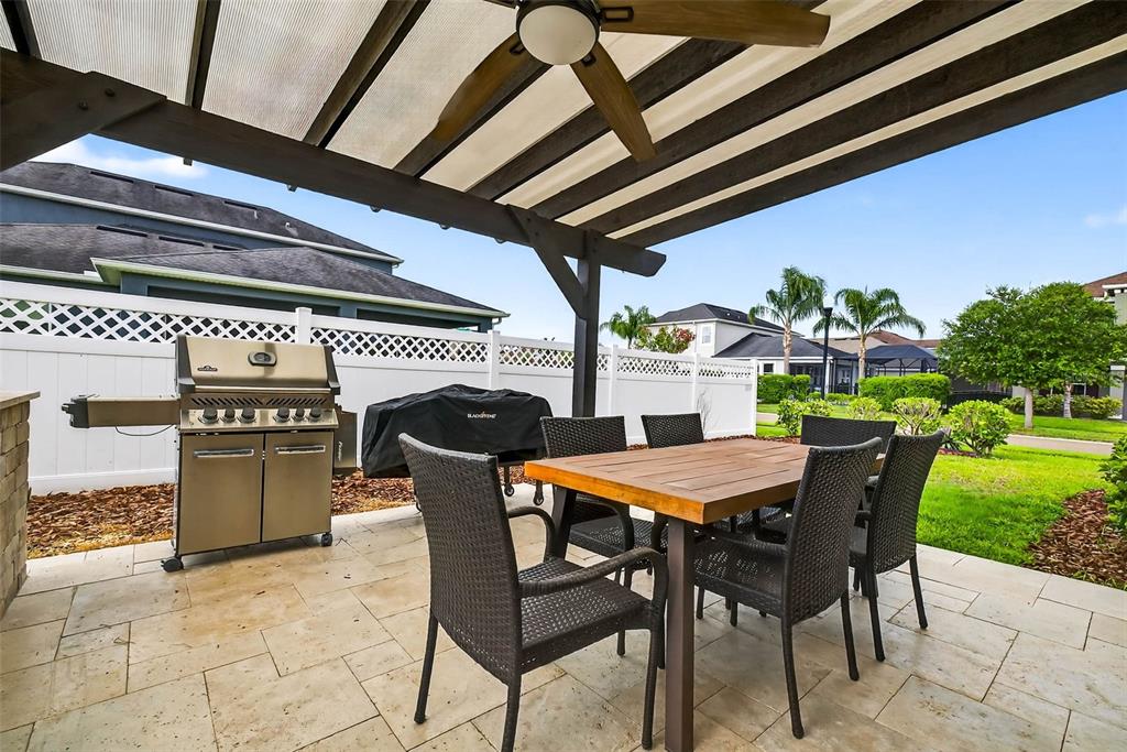 33487 Azalea Ridge Drive Wesley Chapel, FL 33545 - Photo 41 of 56 a patio with a table and chairs and a barbeque