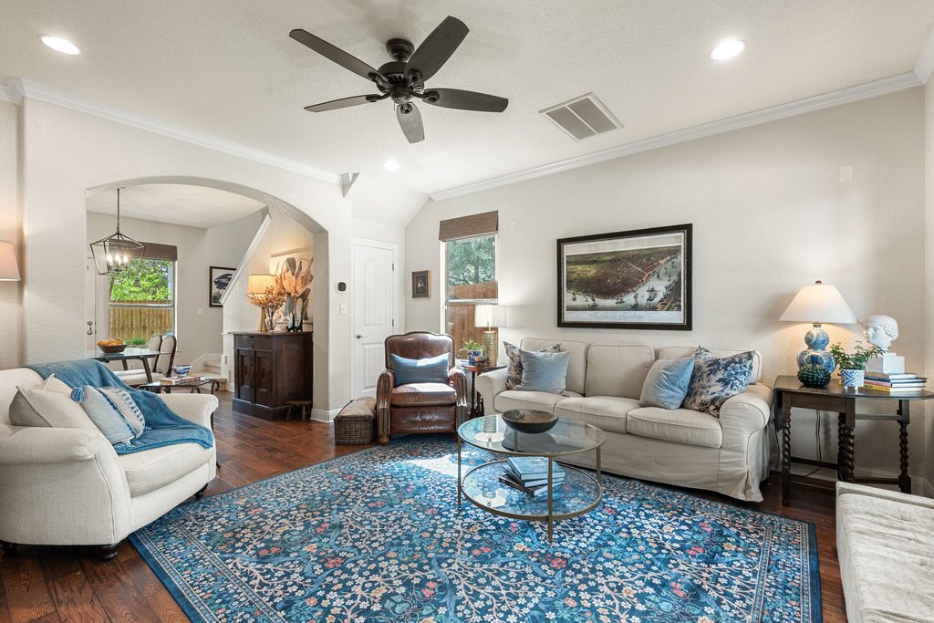 6708 Menchaca Road, Unit 2 Austin, TX 78745 - Photo 13 of 30 Spacious living area featuring wood-finish flooring, an arched doorway, and crown molding