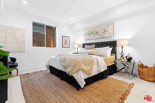 a bedroom with bed and a night stand