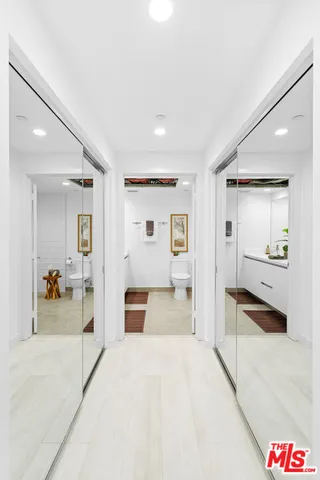 a spacious bedroom with a large bed and dresser