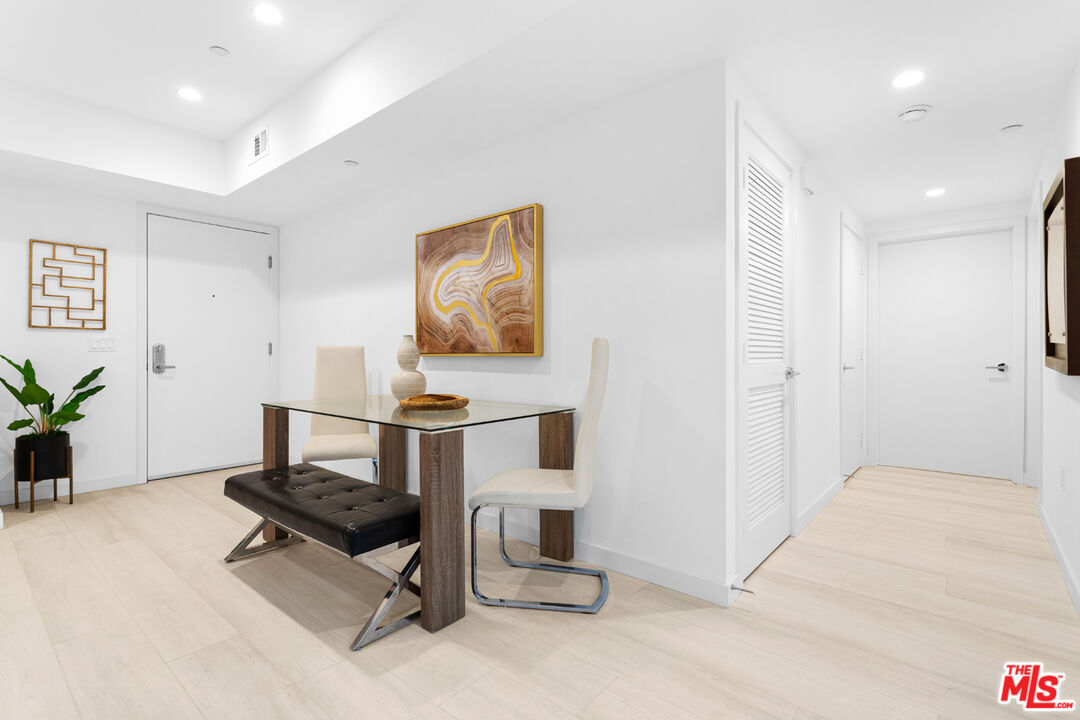 11620 Chenault Street, Unit 304 Los Angeles, CA 90049 - Photo 14 of 19 a living room with furniture and a table