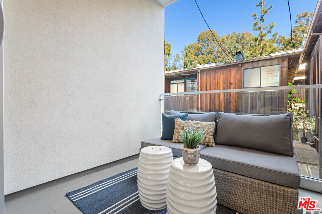 11620 Chenault Street, Unit 304 Los Angeles, CA 90049 - Photo 15 of 19 a living room with furniture and a potted plant