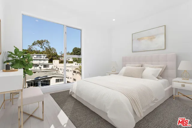a bedroom with a bed and a potted plant