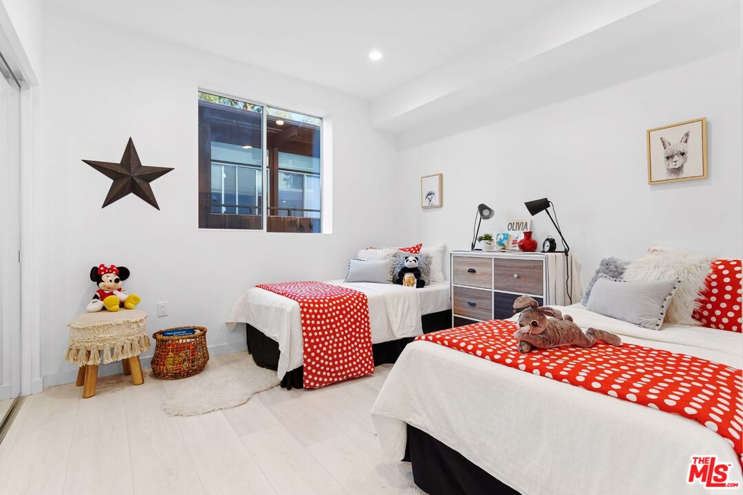 11620 Chenault Street, Unit 304 Los Angeles, CA 90049 - Photo 7 of 19 a bedroom with two beds and a window