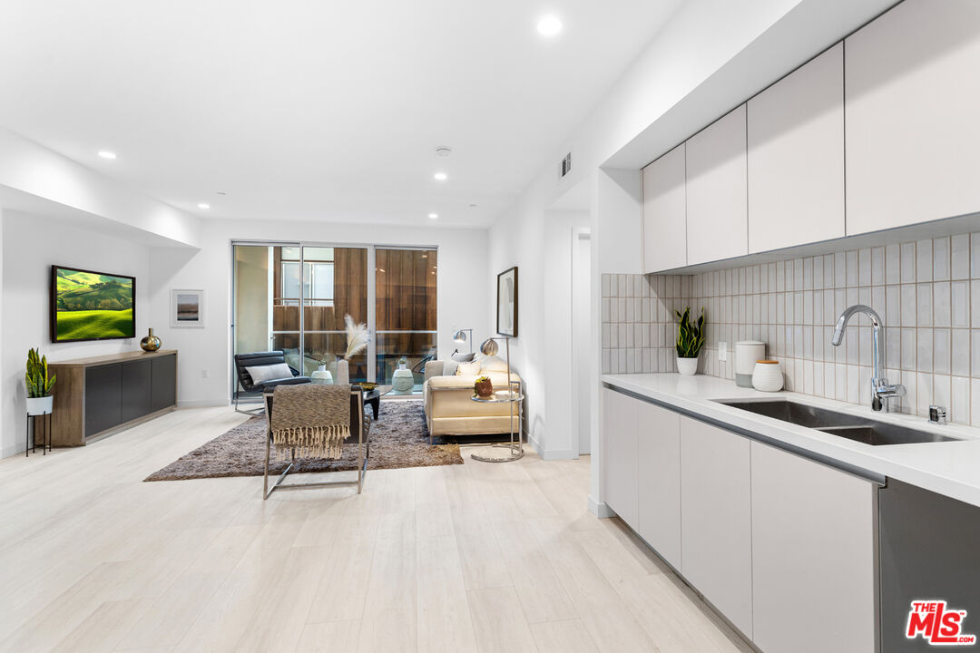 11620 Chenault Street, Unit 304 Los Angeles, CA 90049 - Photo 9 of 19 a kitchen with a sink and living room