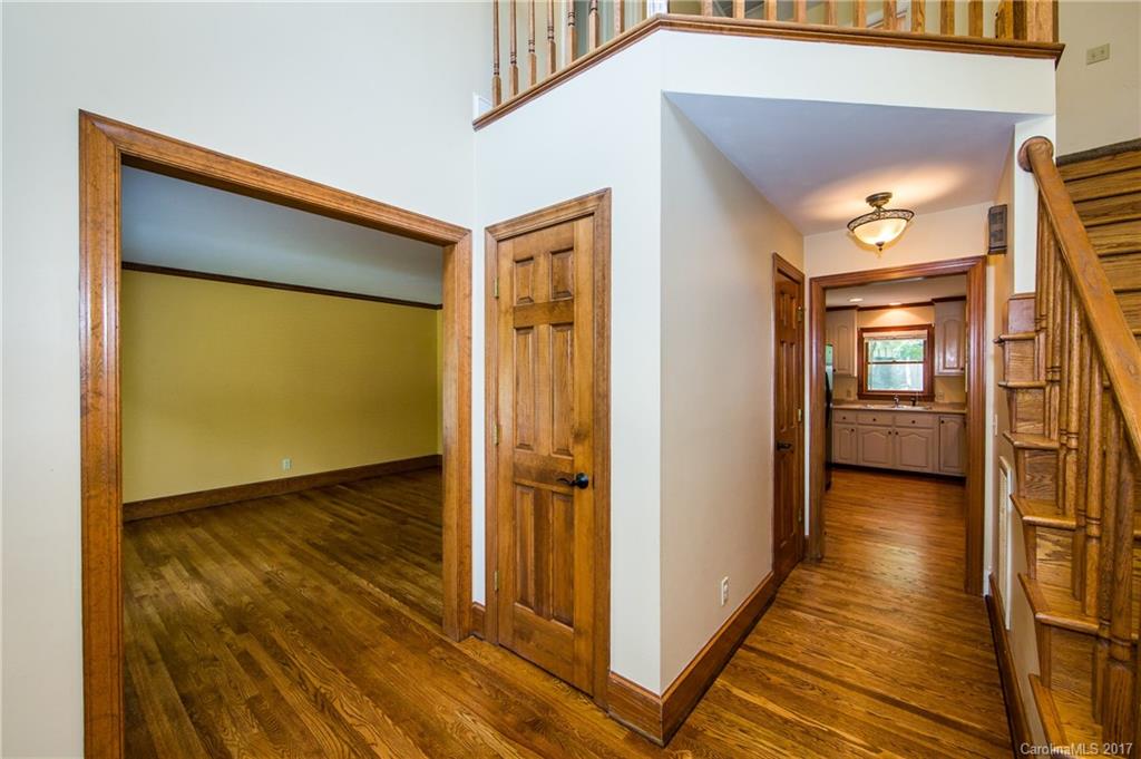 1210 Guildcrest Lane Charlotte, NC 28213 - Photo 3 of 24 a view of a hallway with wooden floor and staircase