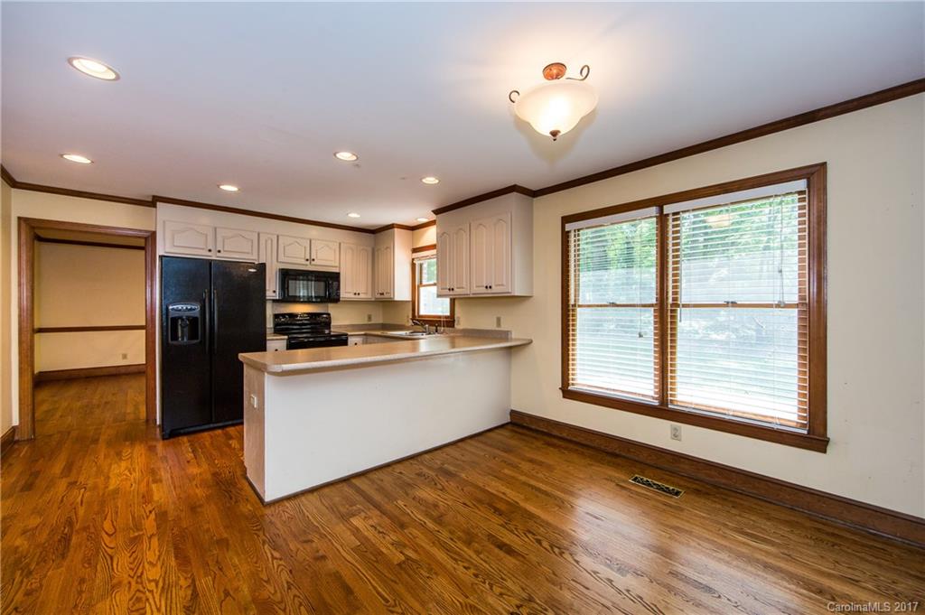 1210 Guildcrest Lane Charlotte, NC 28213 - Photo 8 of 24 a kitchen with stainless steel appliances granite countertop a refrigerator a oven a sink with wooden floors and cabinets