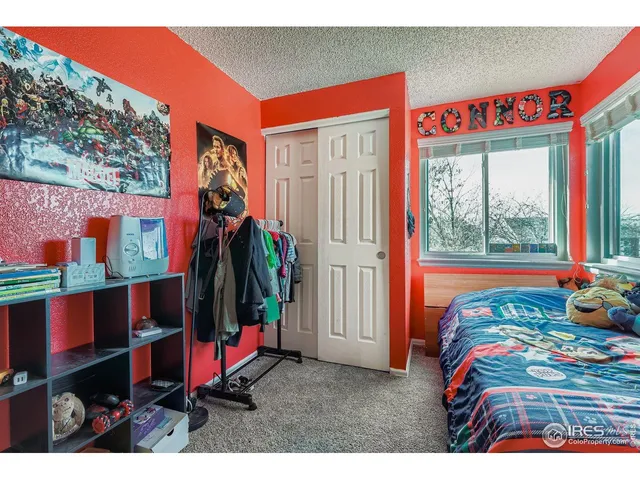 a bedroom with a bed next to a window