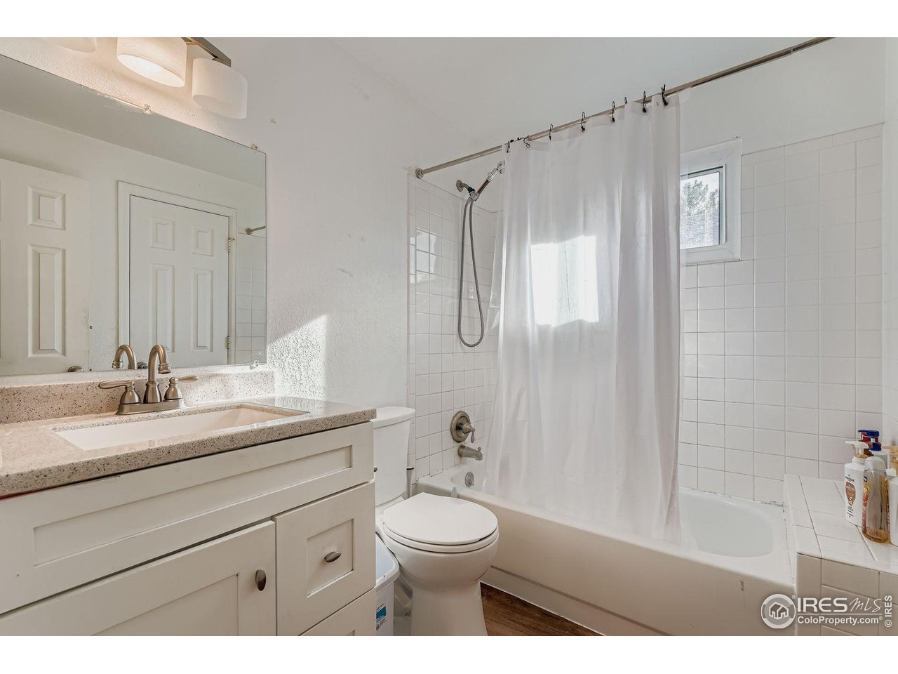 12129 Forest Street Thornton, CO 80241 - Photo 15 of 19 a bathroom with a granite countertop sink toilet a large mirror a shower and a bathtub