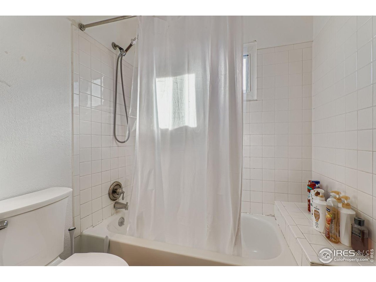 12129 Forest Street Thornton, CO 80241 - Photo 16 of 19 a bathroom with a sink a toilet and shower