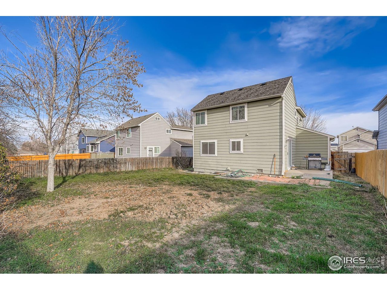 12129 Forest Street Thornton, CO 80241 - Photo 17 of 19 a front view of a house with a yard