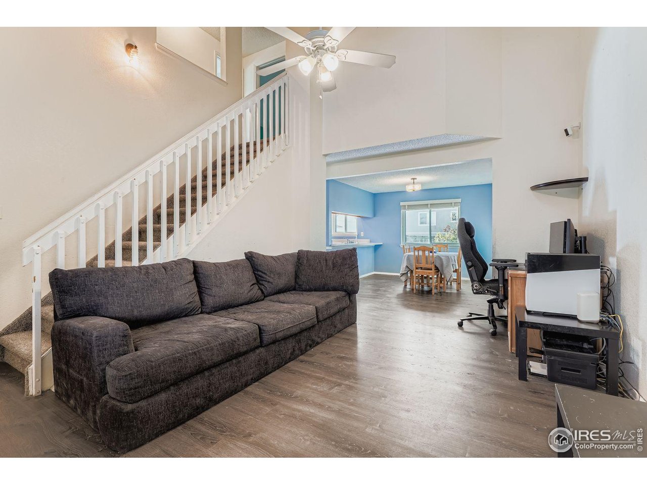 12129 Forest Street Thornton, CO 80241 - Photo 3 of 19 a living room with furniture and a wooden floor