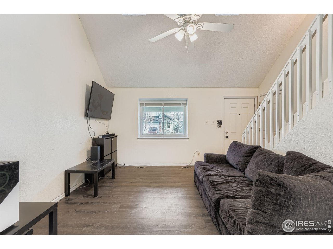 12129 Forest Street Thornton, CO 80241 - Photo 4 of 19 a living room with furniture and a flat screen tv