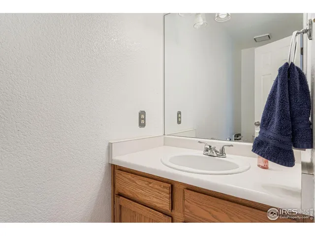 a bathroom with a sink vanity and a mirror