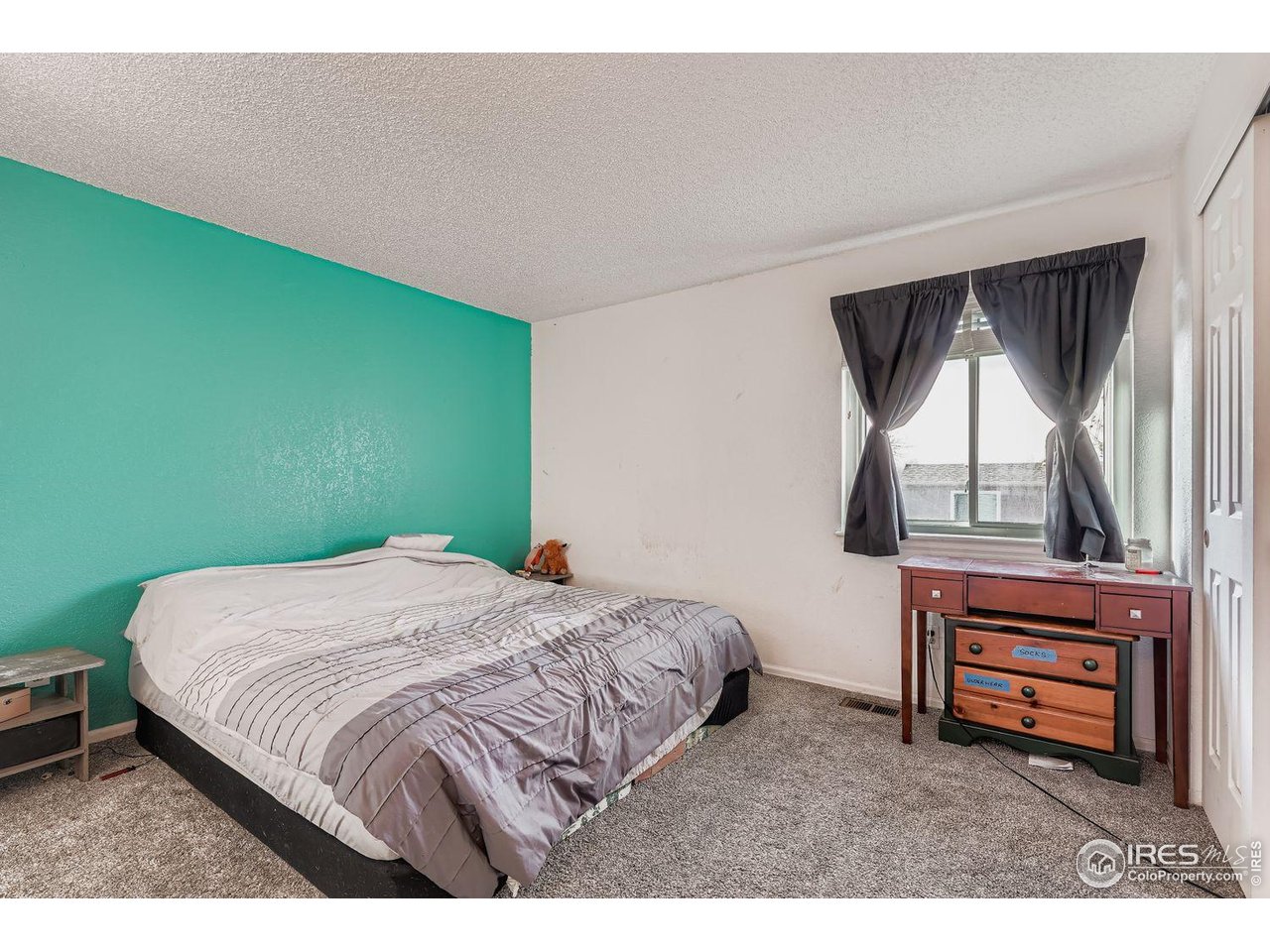 12129 Forest Street Thornton, CO 80241 - Photo 9 of 19 a bedroom with a bed and a window